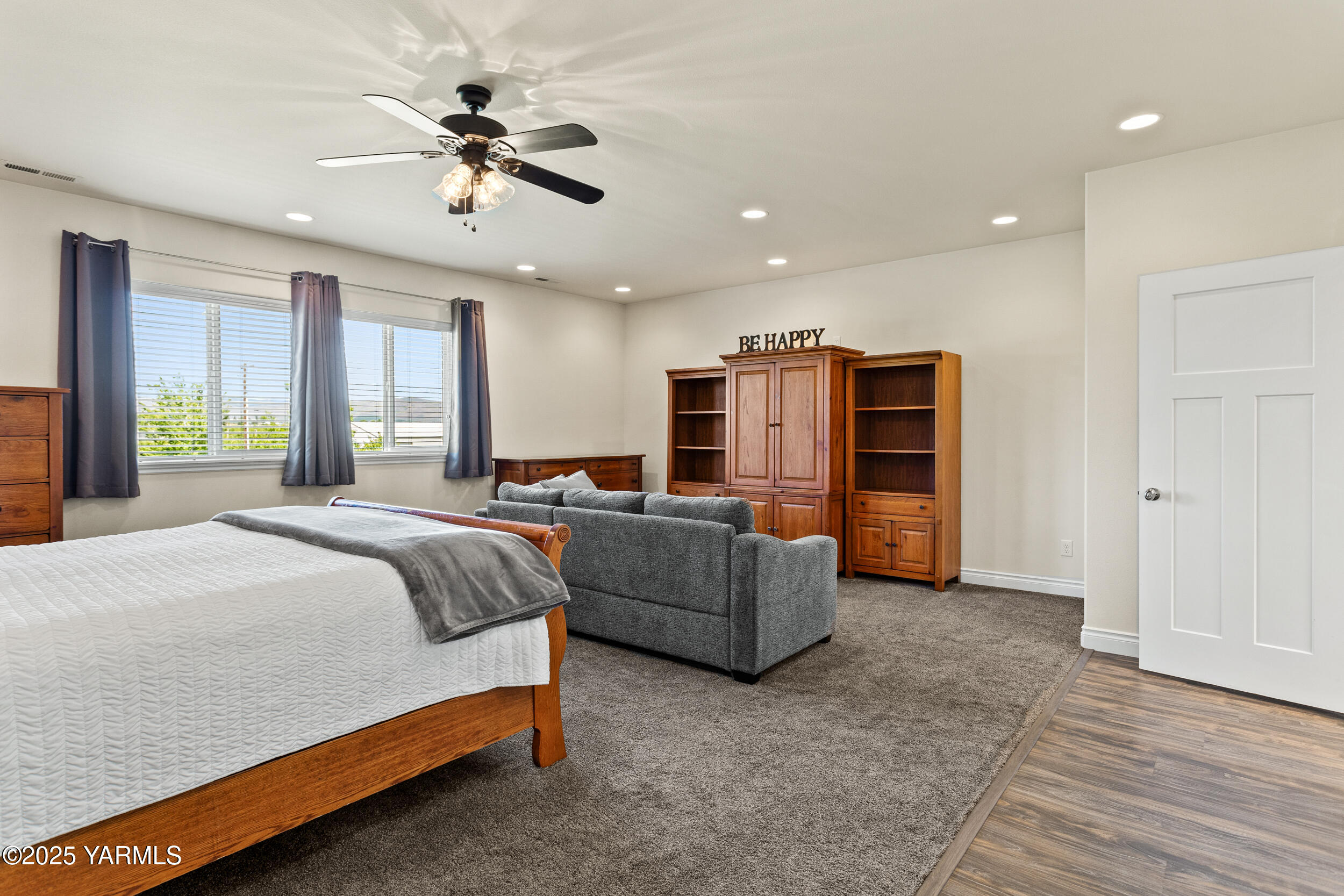 11906 Zier Road Yakima, WA 98908 - Photo 30 of 67 a spacious bedroom with a bed and a chandelier