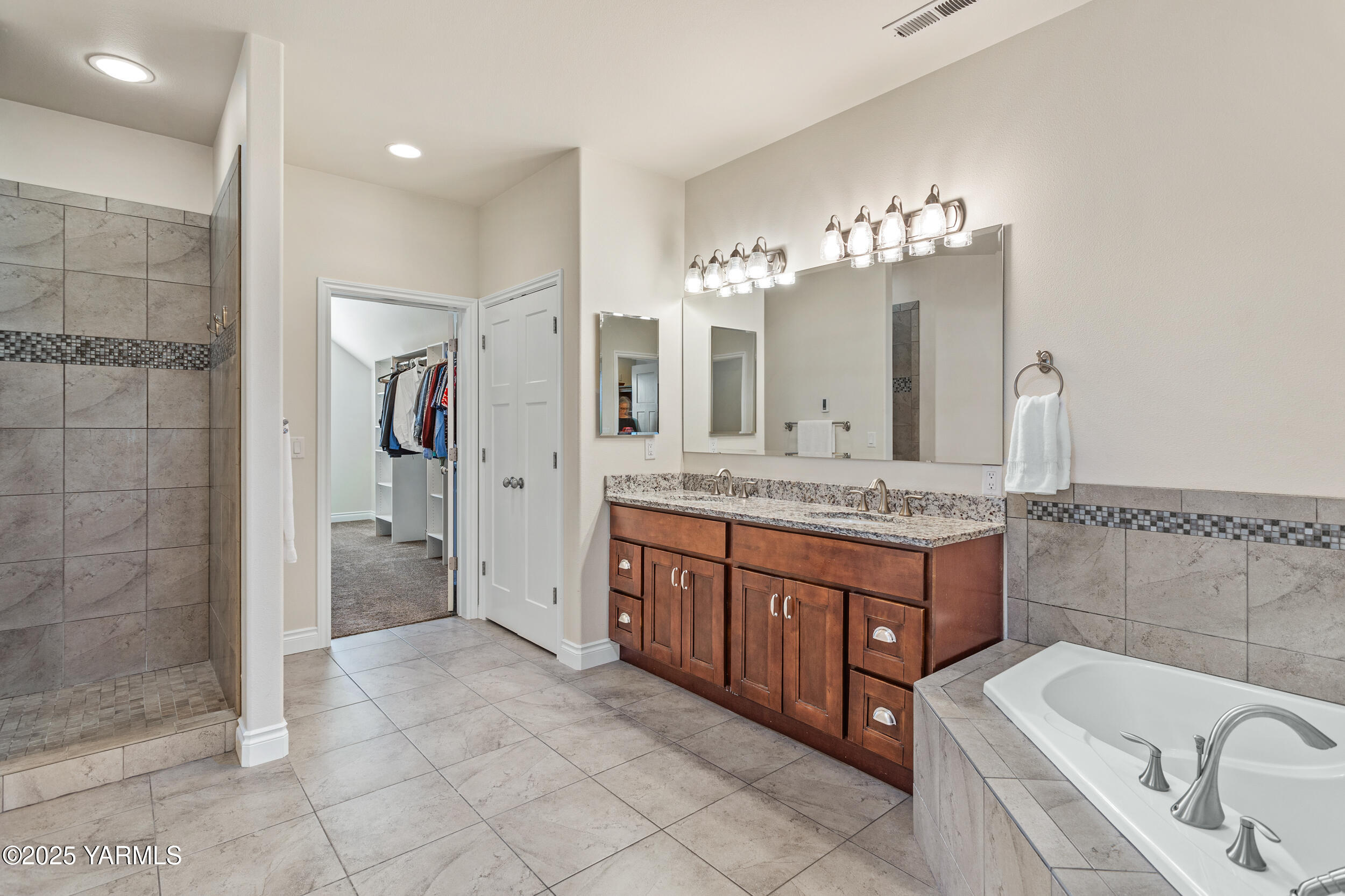 11906 Zier Road Yakima, WA 98908 - Photo 32 of 67 a bathroom with a granite countertop double vanity sink a mirror and a bathtub