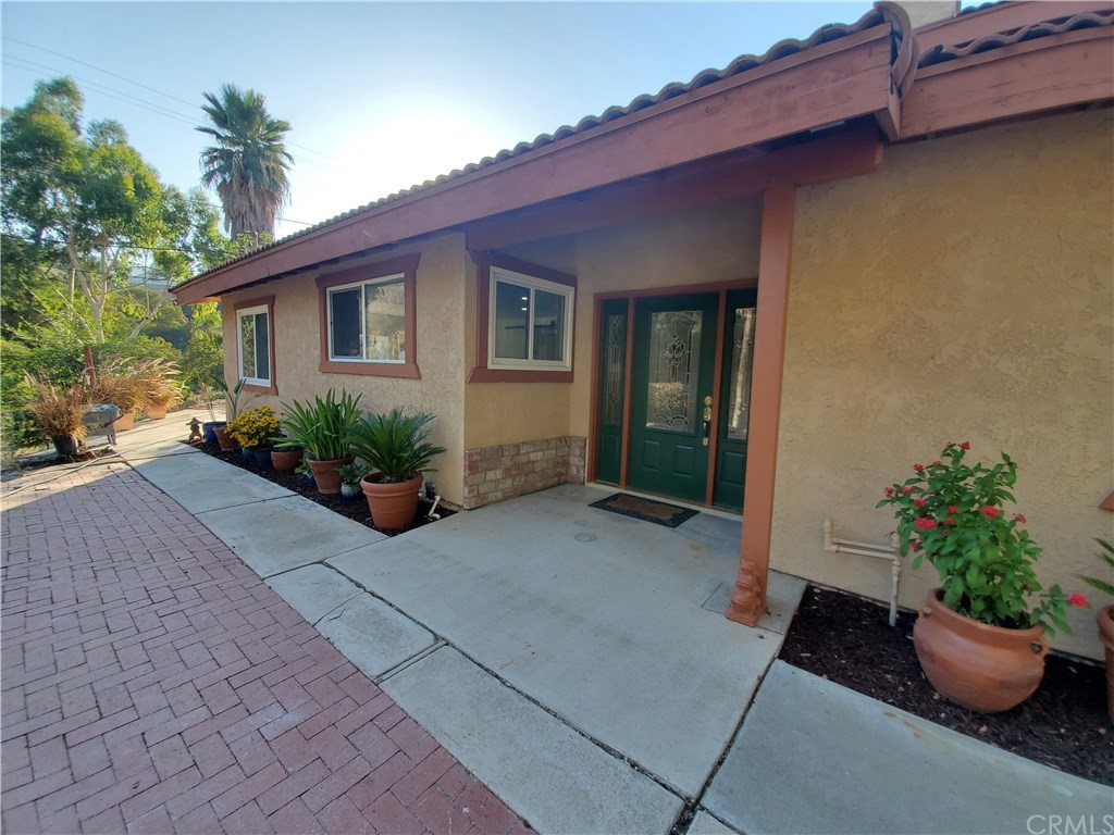 8260 Weirick Road Corona, CA 92883 - Photo 19 of 40 a potted plant sitting in front of a house