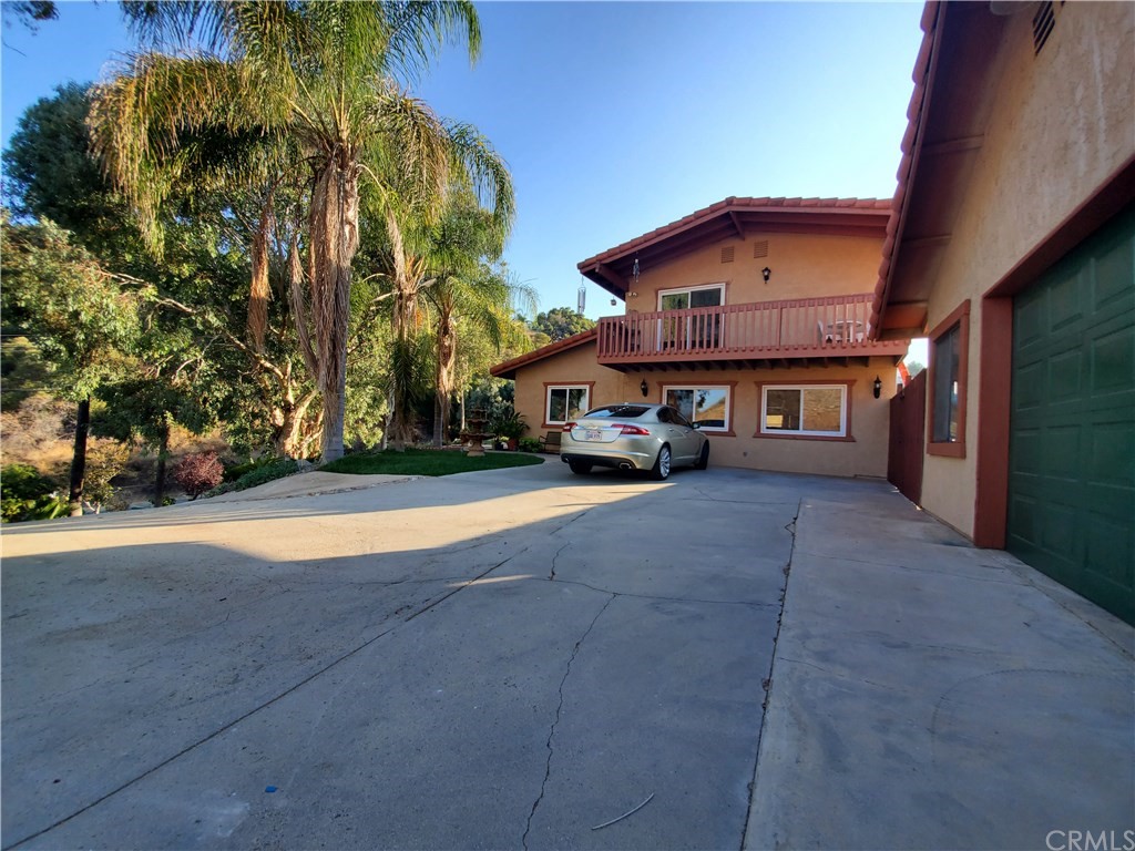 8260 Weirick Road Corona, CA 92883 - Photo 23 of 40 a front view of a house with a yard and garage