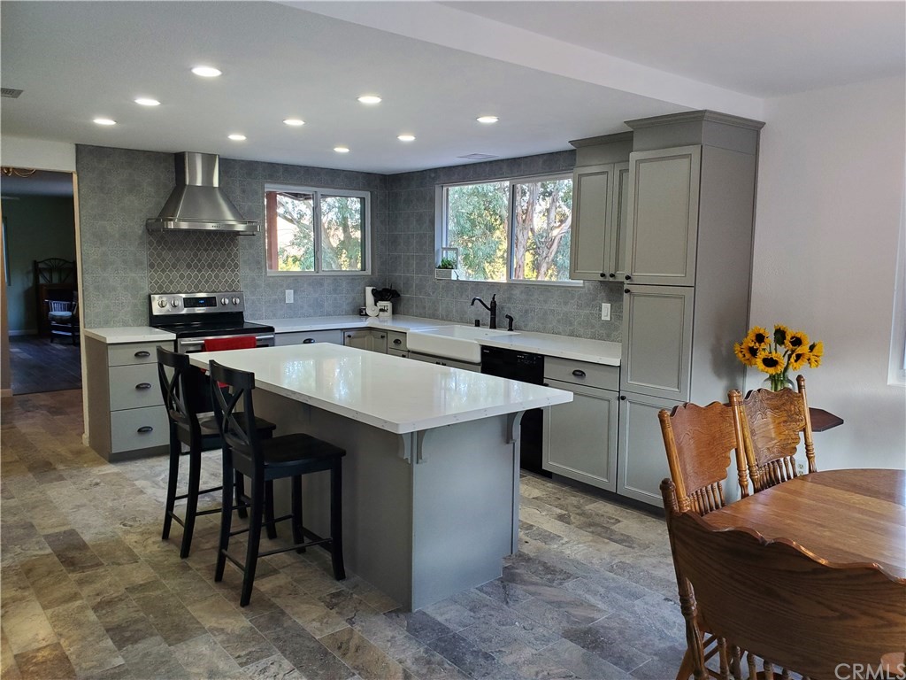 8260 Weirick Road Corona, CA 92883 - Photo 3 of 40 a kitchen with a table chairs sink and cabinets