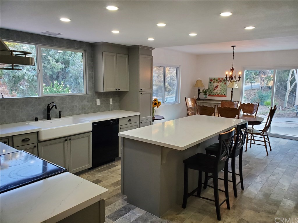 8260 Weirick Road Corona, CA 92883 - Photo 4 of 40 a kitchen with a table chairs sink and cabinets