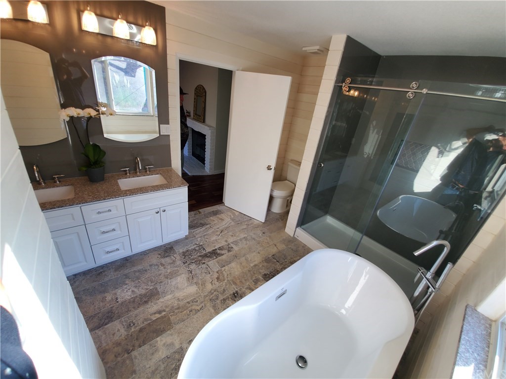 8260 Weirick Road Corona, CA 92883 - Photo 8 of 40 a bathroom with a sink a toilet and mirror