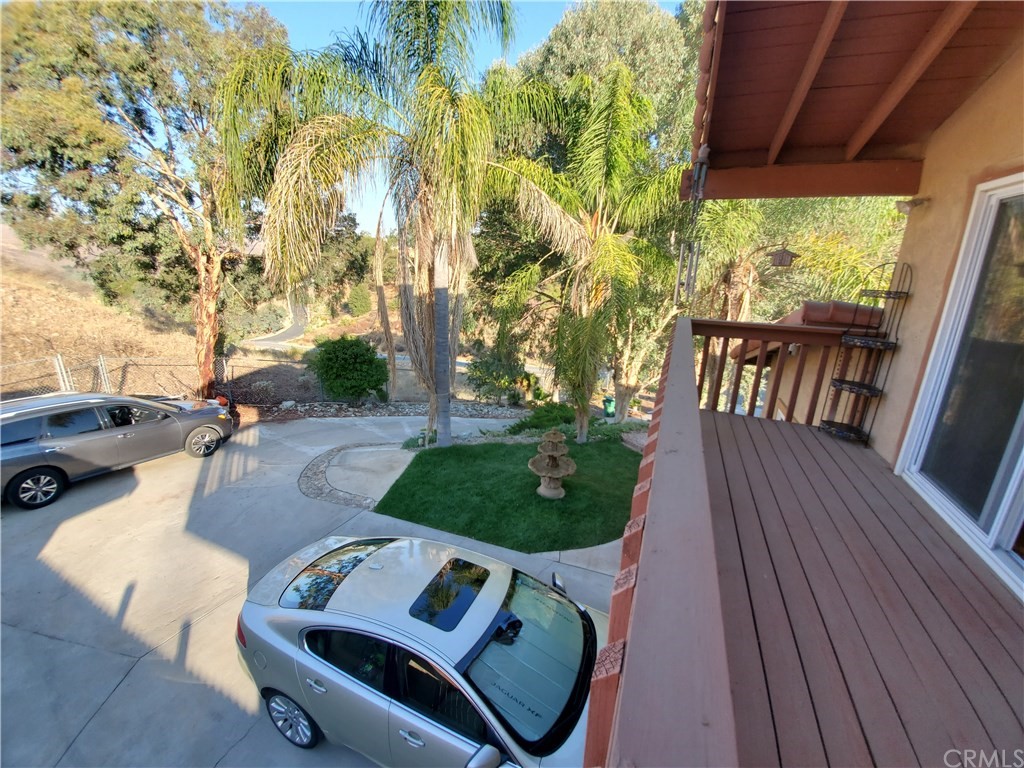 8260 Weirick Road Corona, CA 92883 - Photo 9 of 40 a view of a patio with table and chairs with wooden floor and fence