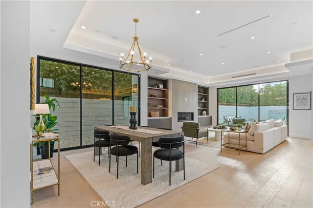 a dining hall with stainless steel appliances granite countertop a stove and kitchen view