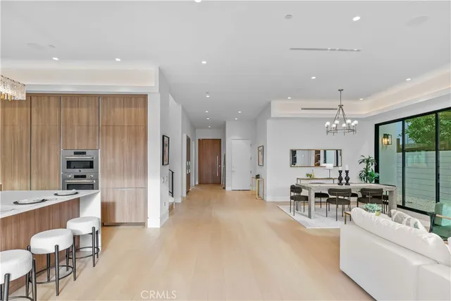 a kitchen with kitchen island granite countertop a sink refrigerator and cabinets