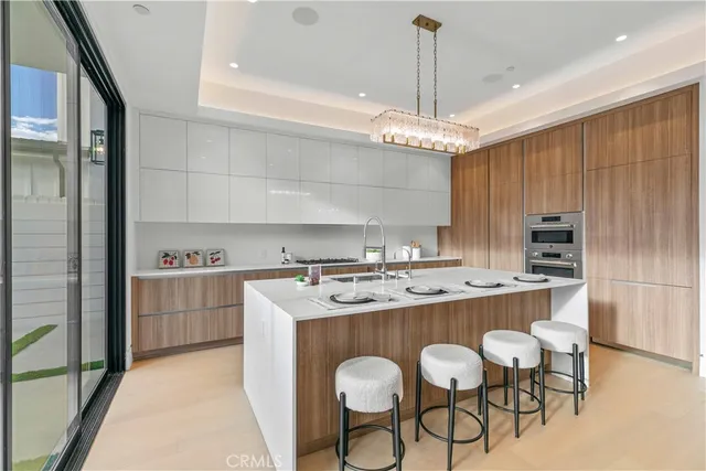 a kitchen with sink and view of living room