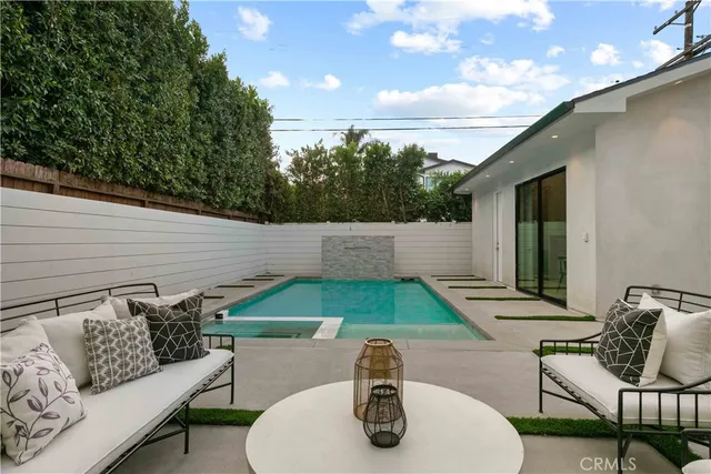 a view of a patio with table and chairs