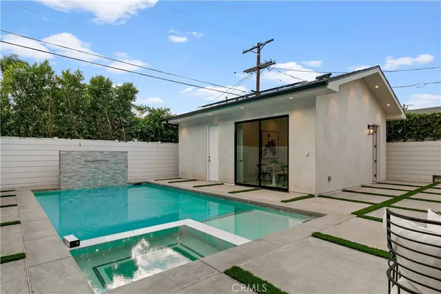 a view of a patio with table and chairs under an umbrella