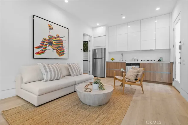 a living room with furniture and kitchen view