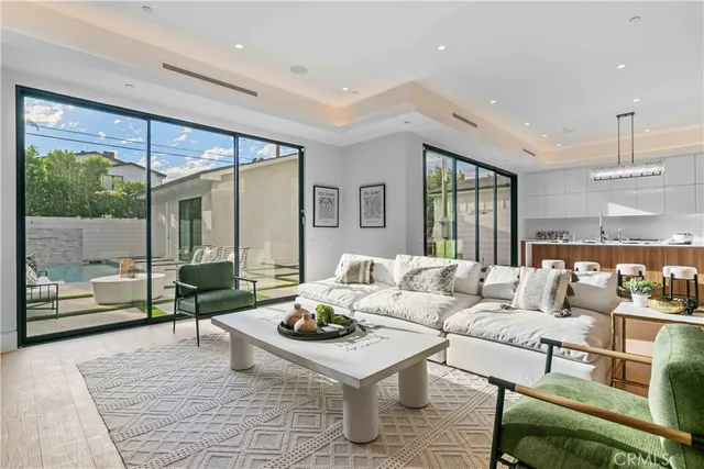 a view of a hallway with wooden floor and stairs