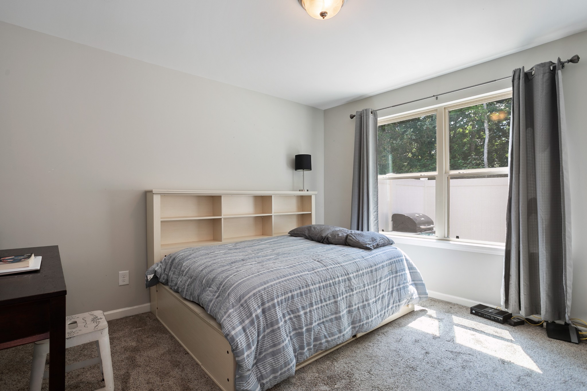 1076 Neeleys Bend East Spring Hill, TN 37174 - Photo 14 of 27 a bedroom with a large bed and a large window