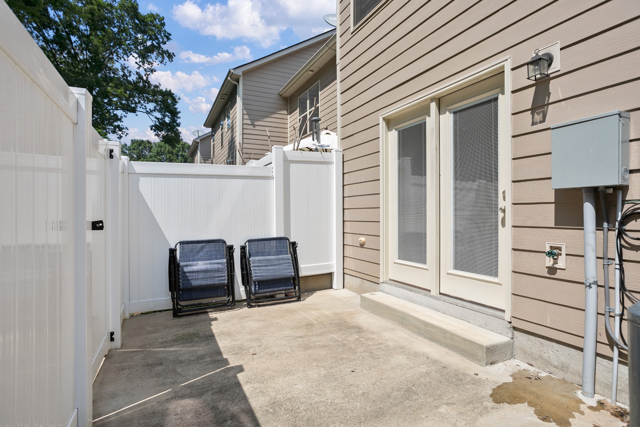 1076 Neeleys Bend East Spring Hill, TN 37174 - Photo 24 of 27 a view of a patio with table and chairs and iron fence