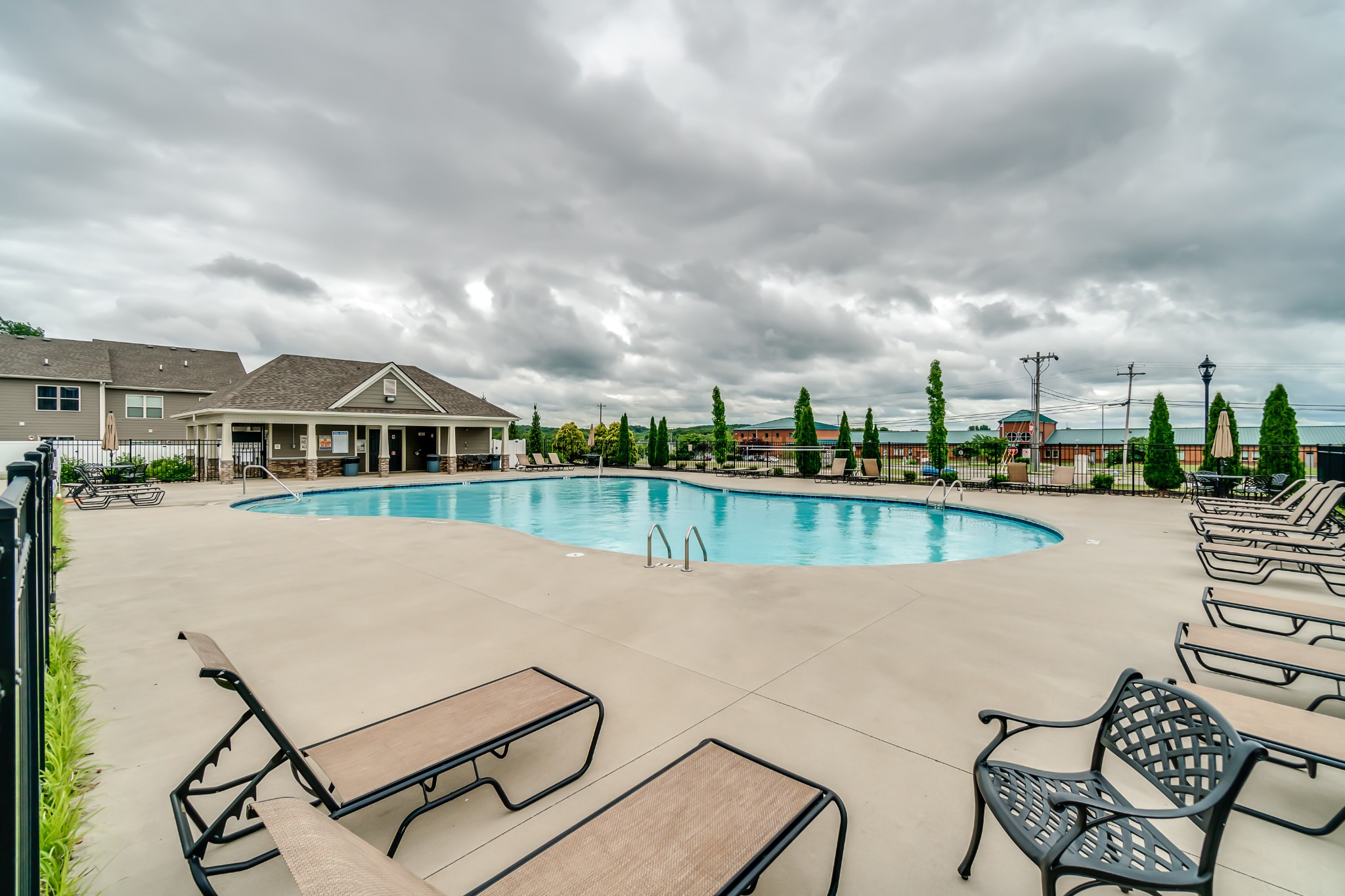 1076 Neeleys Bend East Spring Hill, TN 37174 - Photo 27 of 27 a view of swimming pool that has lawn chairs with plants and lake view