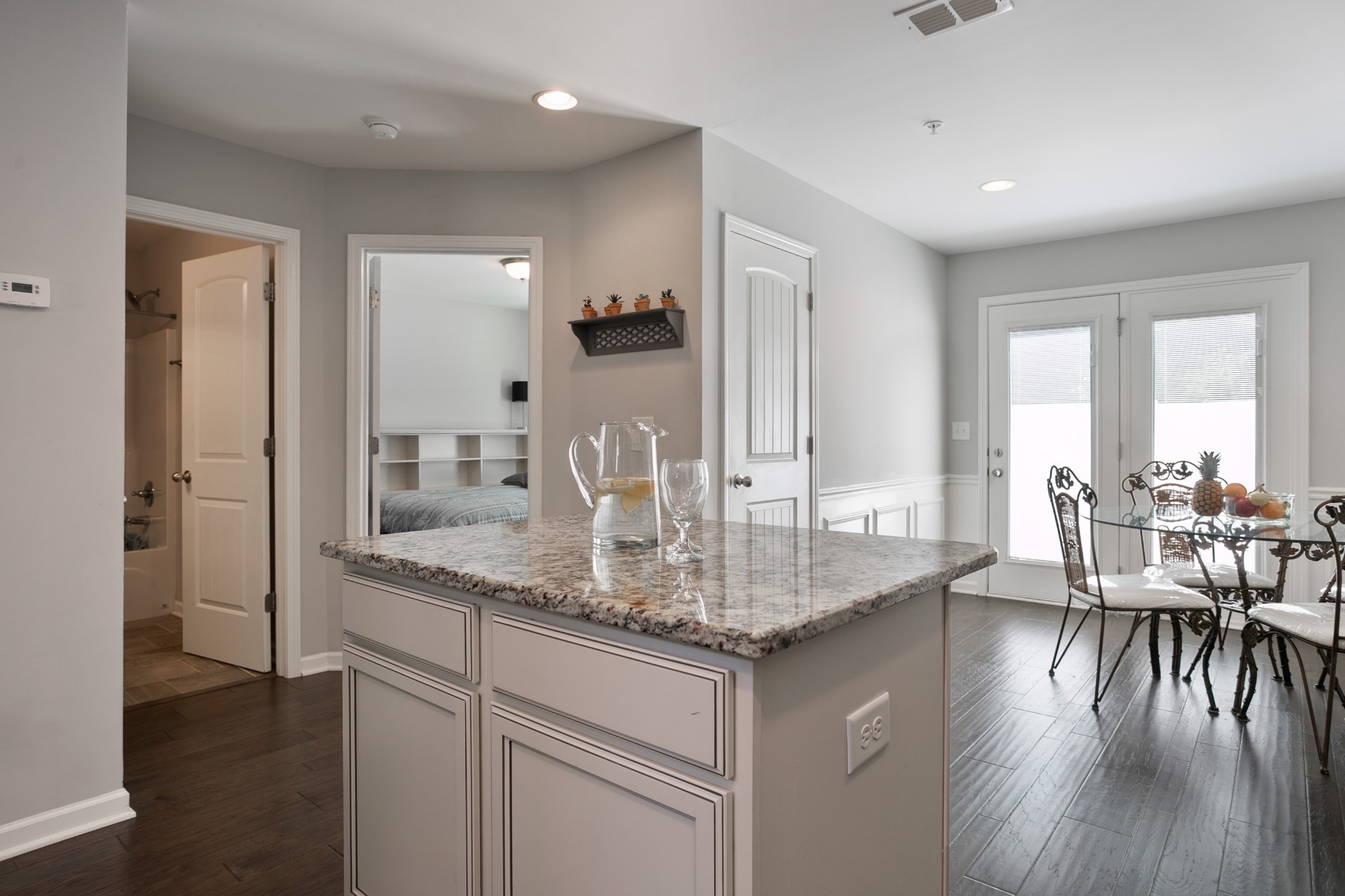 1076 Neeleys Bend East Spring Hill, TN 37174 - Photo 10 of 27 a kitchen with center island wooden floor and a dining table