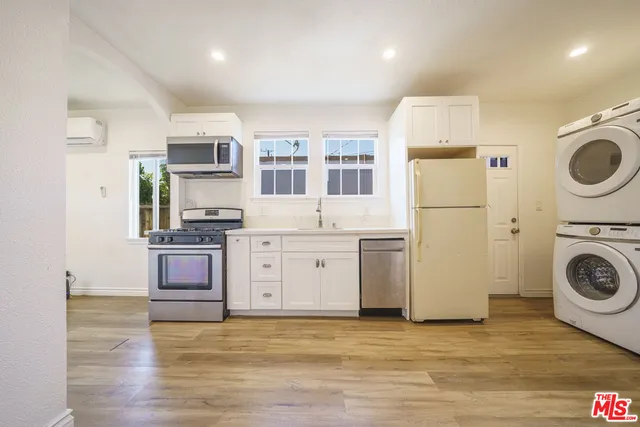a view of a kitchen with stove and refrigerator