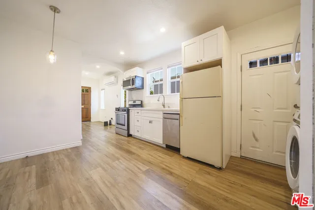 a view of a kitchen with wooden floor
