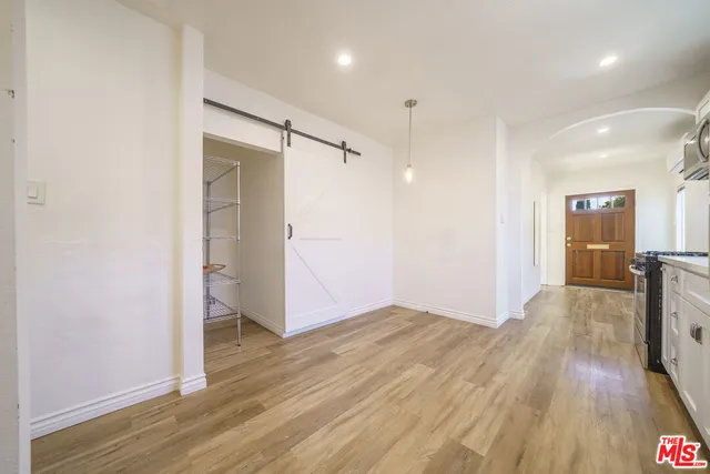 a view of empty room with wooden floor