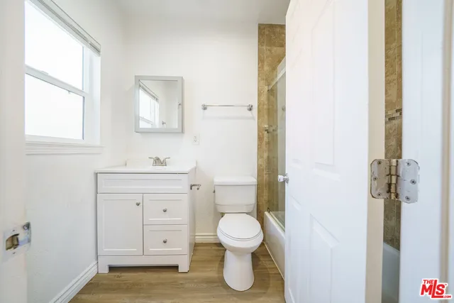 a bathroom with a toilet a sink and a window