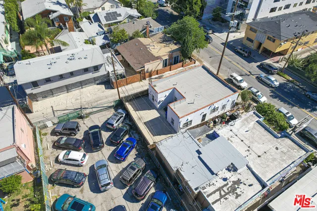 an aerial view of a house with outdoor seating