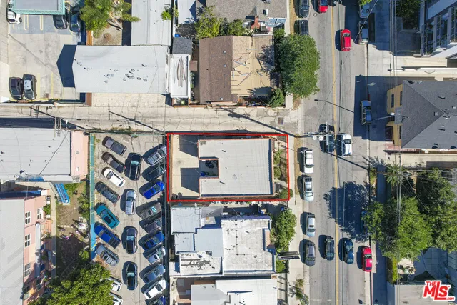 a aerial view of multi story residential apartment building with yard