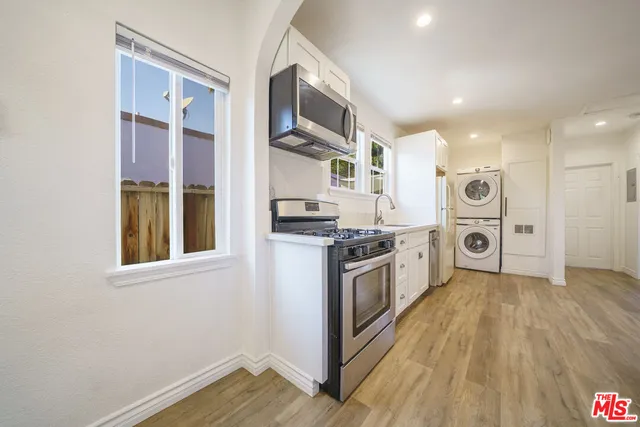 a kitchen with stainless steel appliances granite countertop a stove and a refrigerator