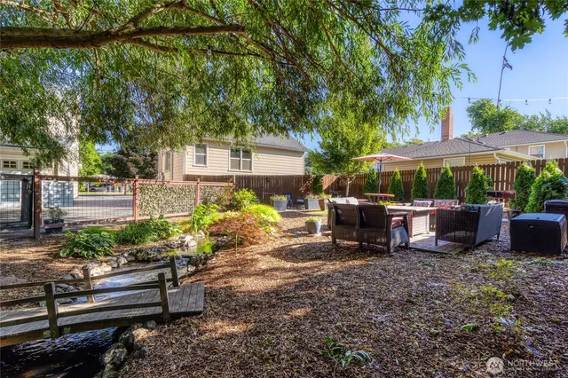 a view of a backyard with plants and a patio