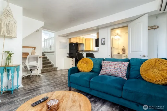 a living room with furniture and a wooden floor
