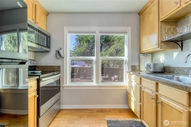 a kitchen with stainless steel appliances granite countertop a stove and a sink