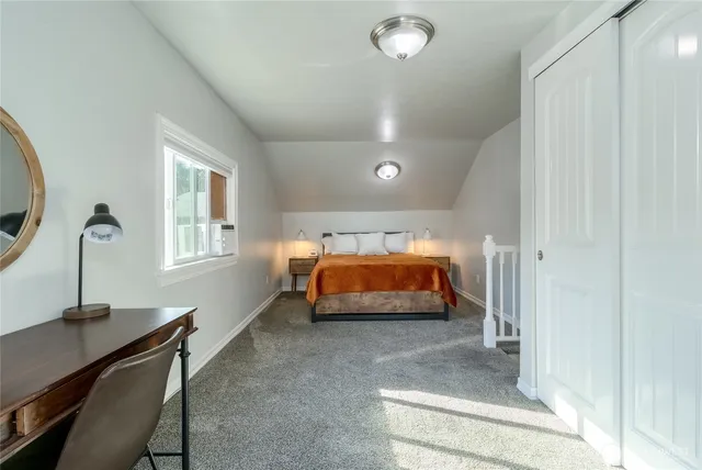 a bedroom with bed and window