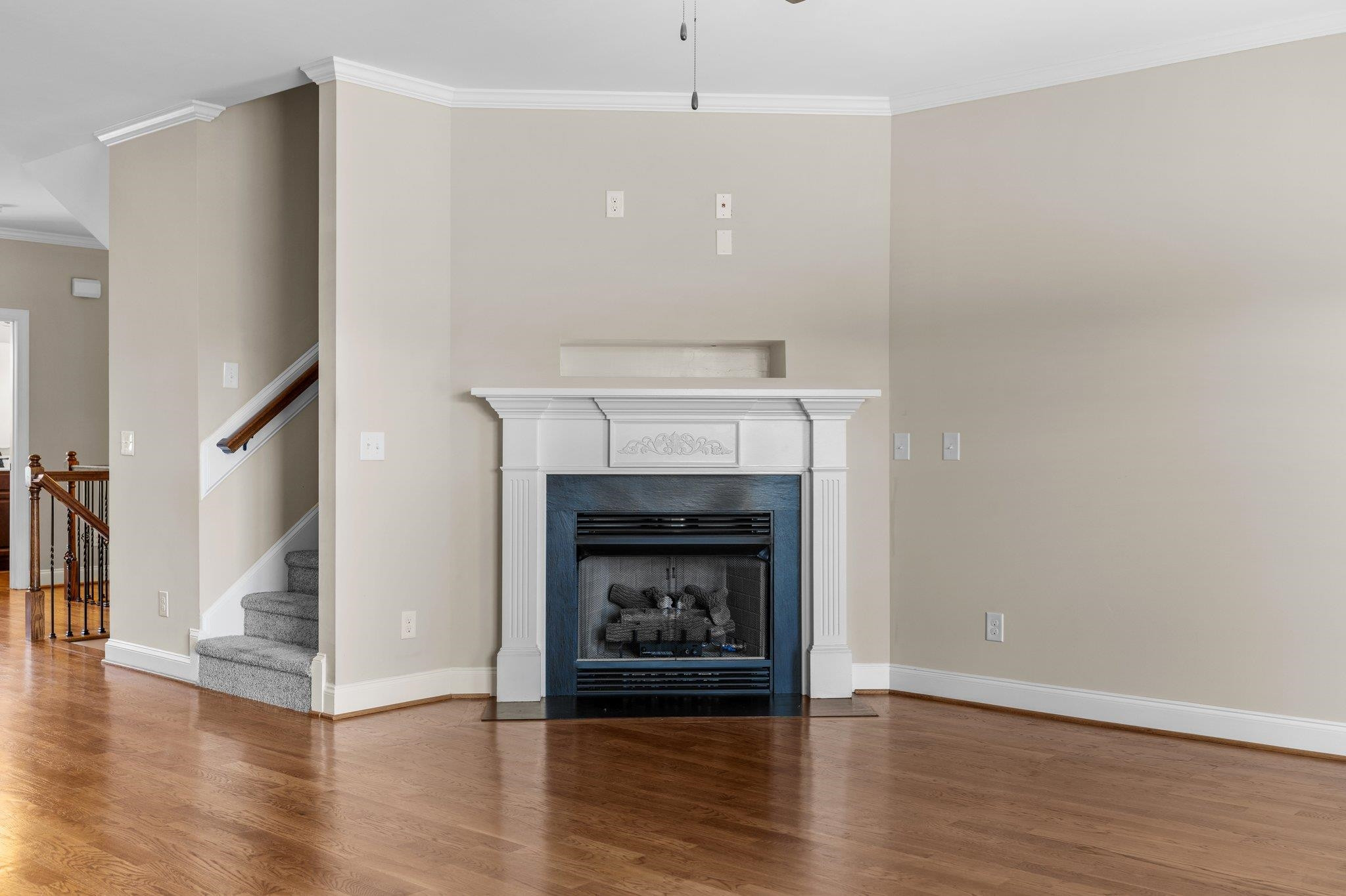 905 Shoofly Path Apex, NC 27502 - Photo 11 of 31 a room with a fireplace and wooden floor