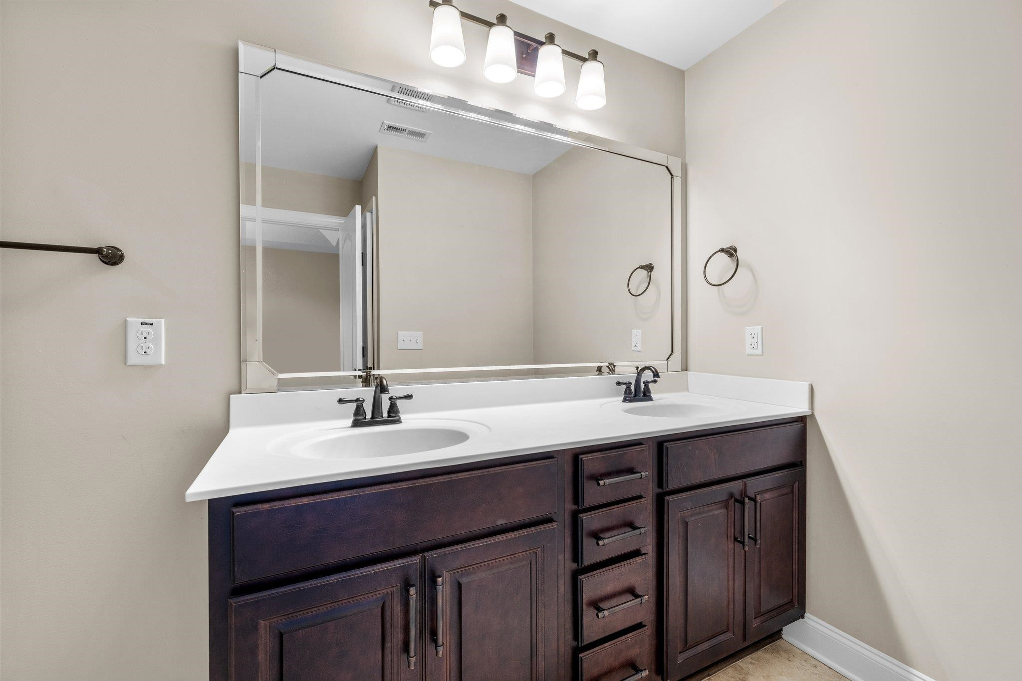 905 Shoofly Path Apex, NC 27502 - Photo 14 of 31 a bathroom with a double vanity sink and a mirror