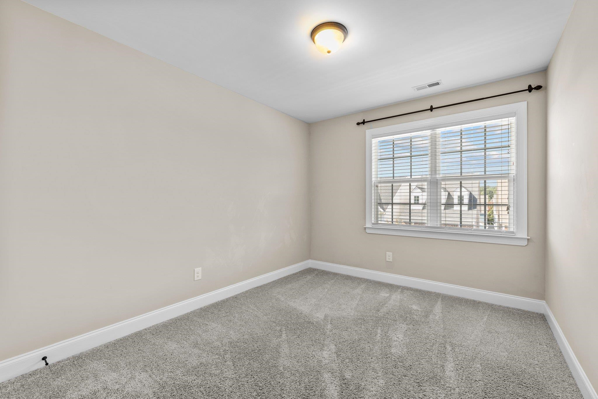 905 Shoofly Path Apex, NC 27502 - Photo 18 of 31 an empty room with windows