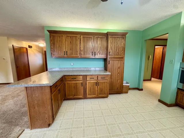 a kitchen with stainless steel appliances granite countertop a stove a refrigerator and a sink