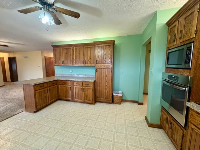 a kitchen with stainless steel appliances a sink and a refrigerator