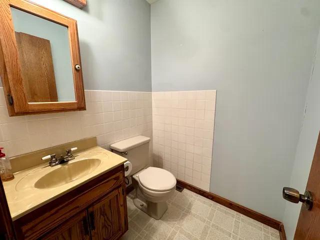 a bathroom with a sink a toilet and mirror