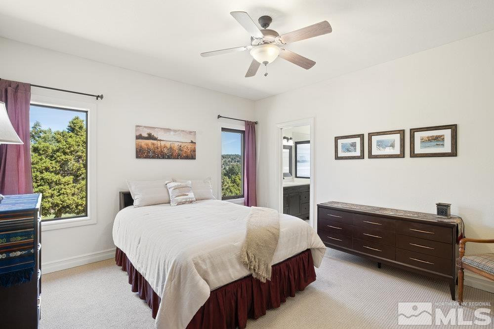 21860 Bowie Road Reno, NV 89521 - Photo 12 of 24 a bedroom with a bed dresser and a window