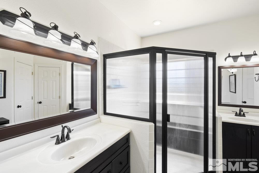 21860 Bowie Road Reno, NV 89521 - Photo 14 of 24 a bathroom with a double vanity sink and mirror