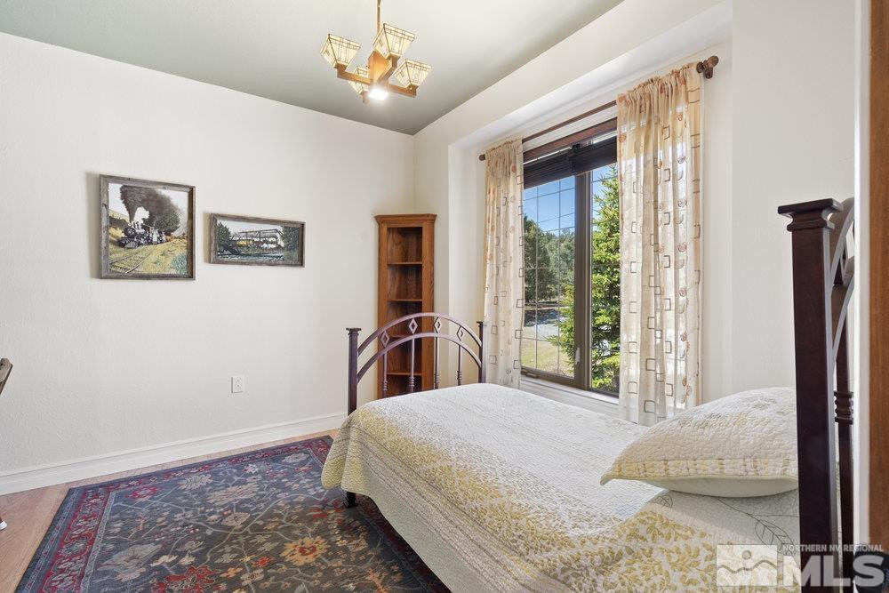 21860 Bowie Road Reno, NV 89521 - Photo 15 of 24 a bedroom with a large bed and a window