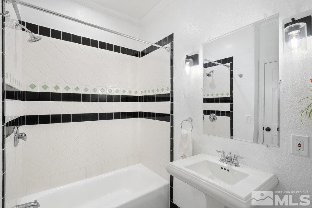 21860 Bowie Road Reno, NV 89521 - Photo 16 of 24 a bathroom with a bathtub and a shower