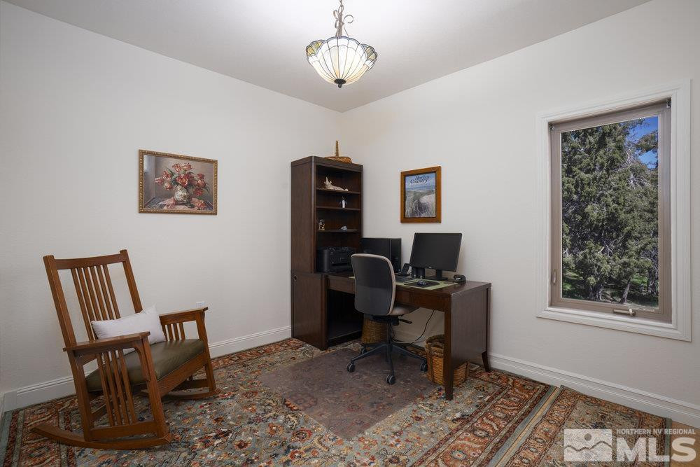 21860 Bowie Road Reno, NV 89521 - Photo 17 of 24 a view of a workspace with furniture and a window