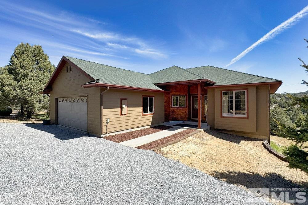 21860 Bowie Road Reno, NV 89521 - Photo 2 of 24 a front view of a house with a yard
