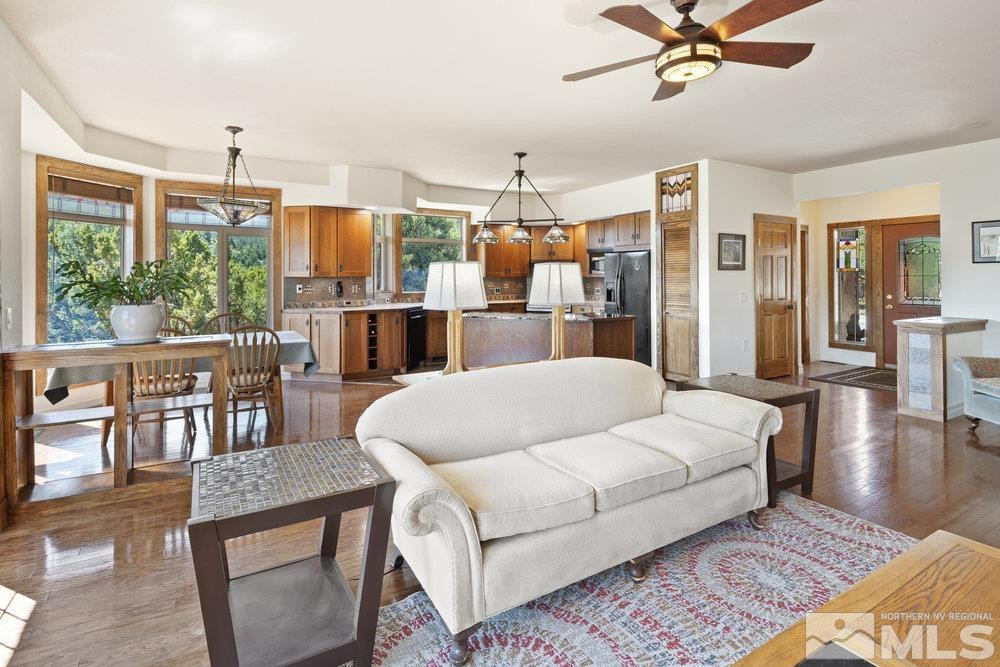 21860 Bowie Road Reno, NV 89521 - Photo 6 of 24 a bed room with a bed a couch and a chandelier