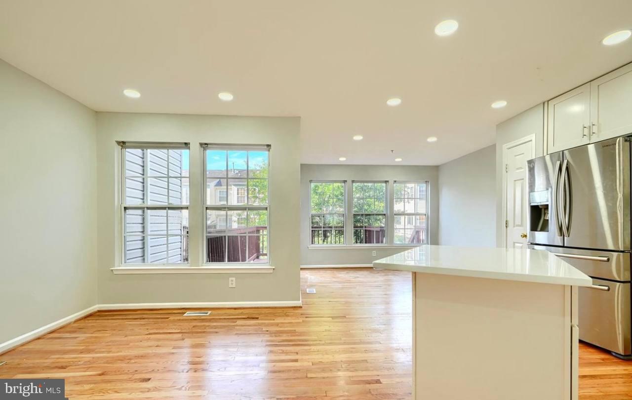 9863 Decatur Road Middle River, MD 21220 - Photo 13 of 33 a view of an empty room with wooden floor and a window