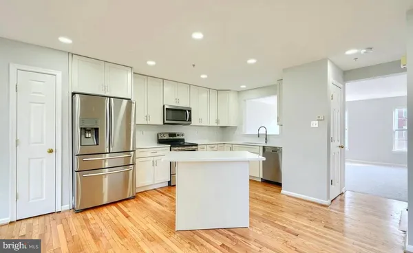 a kitchen with a sink stove top oven and microwave