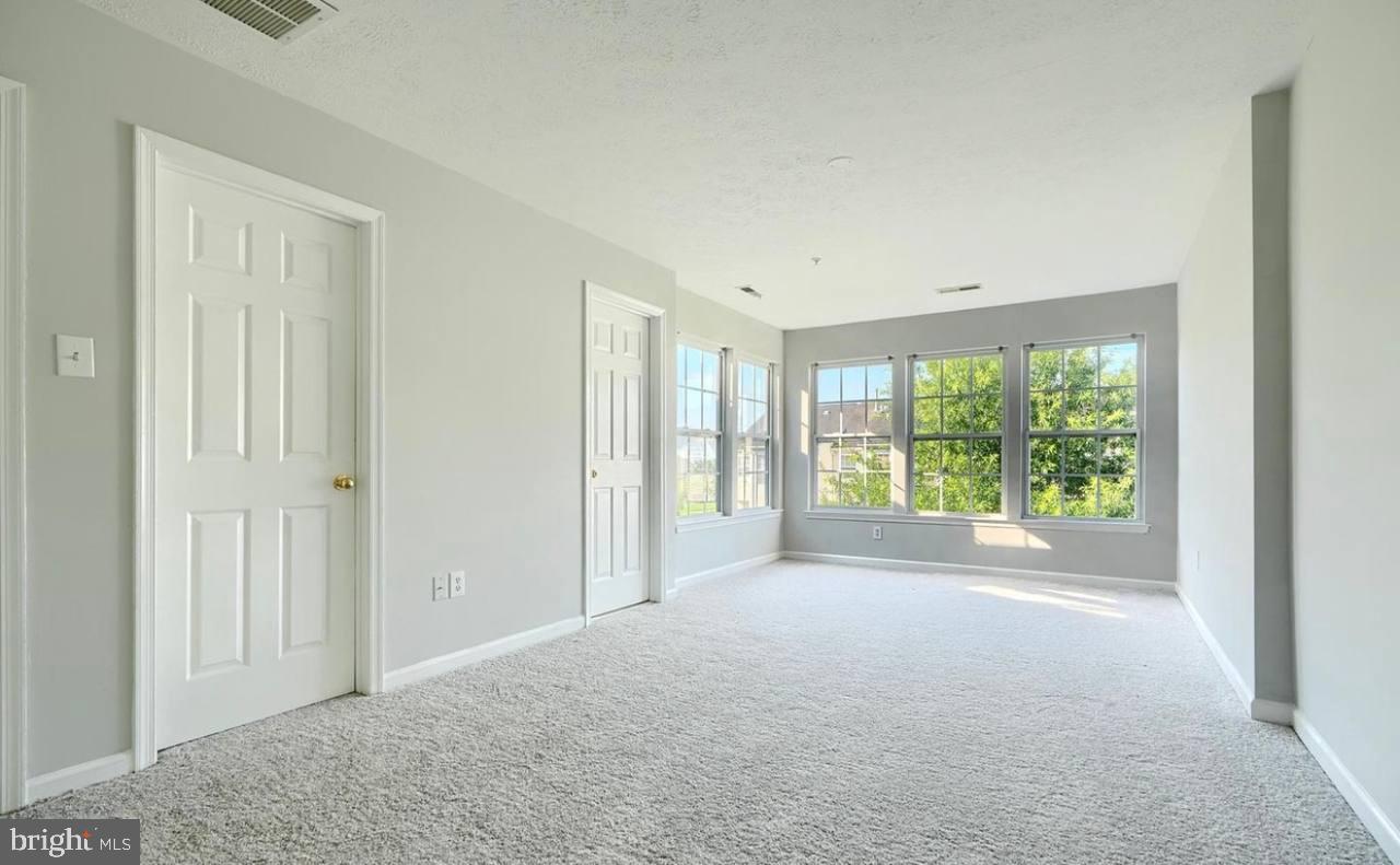9863 Decatur Road Middle River, MD 21220 - Photo 23 of 33 a view of a big room with windows and chandelier fan