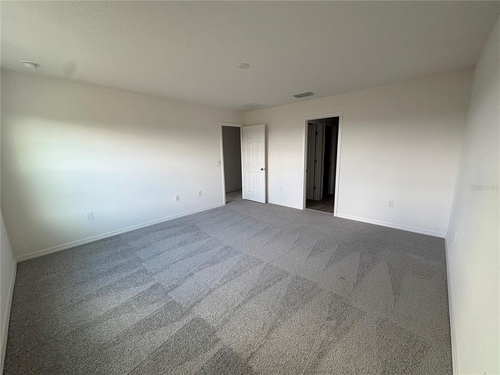 2529 Starry Point St. Cloud, FL 34769 - Photo 15 of 21 a view of an empty room with wooden floor