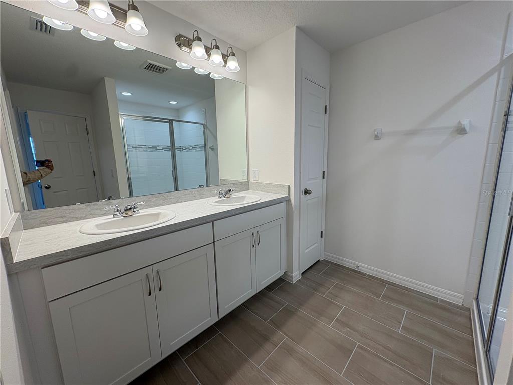 2529 Starry Point St. Cloud, FL 34769 - Photo 17 of 21 a bathroom with a double vanity sink and a mirror