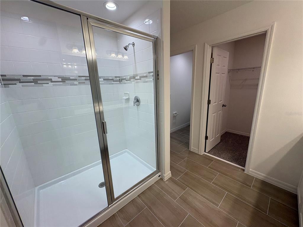 2529 Starry Point St. Cloud, FL 34769 - Photo 18 of 21 a bathroom with a glass shower door and a sink