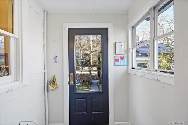 a view of an entryway with wooden floor